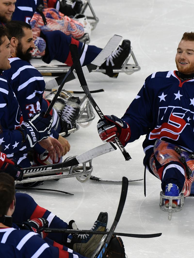 Two Para ice hockey players smile after a game