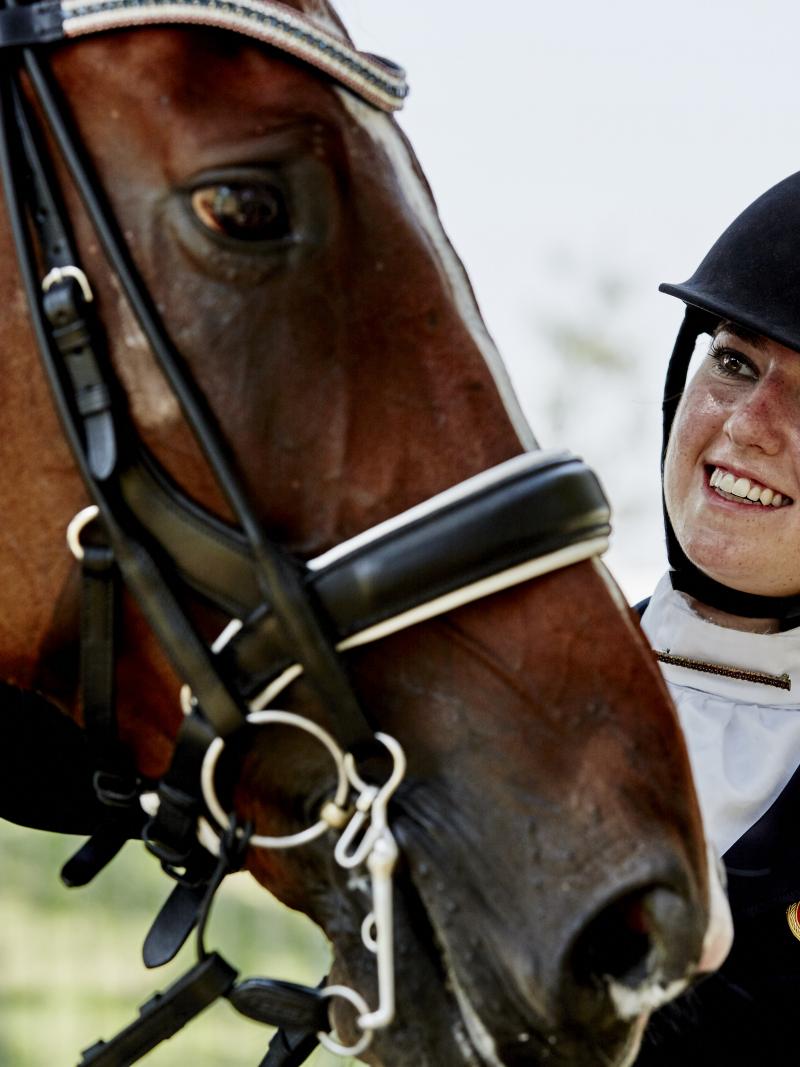 Woman pets horse