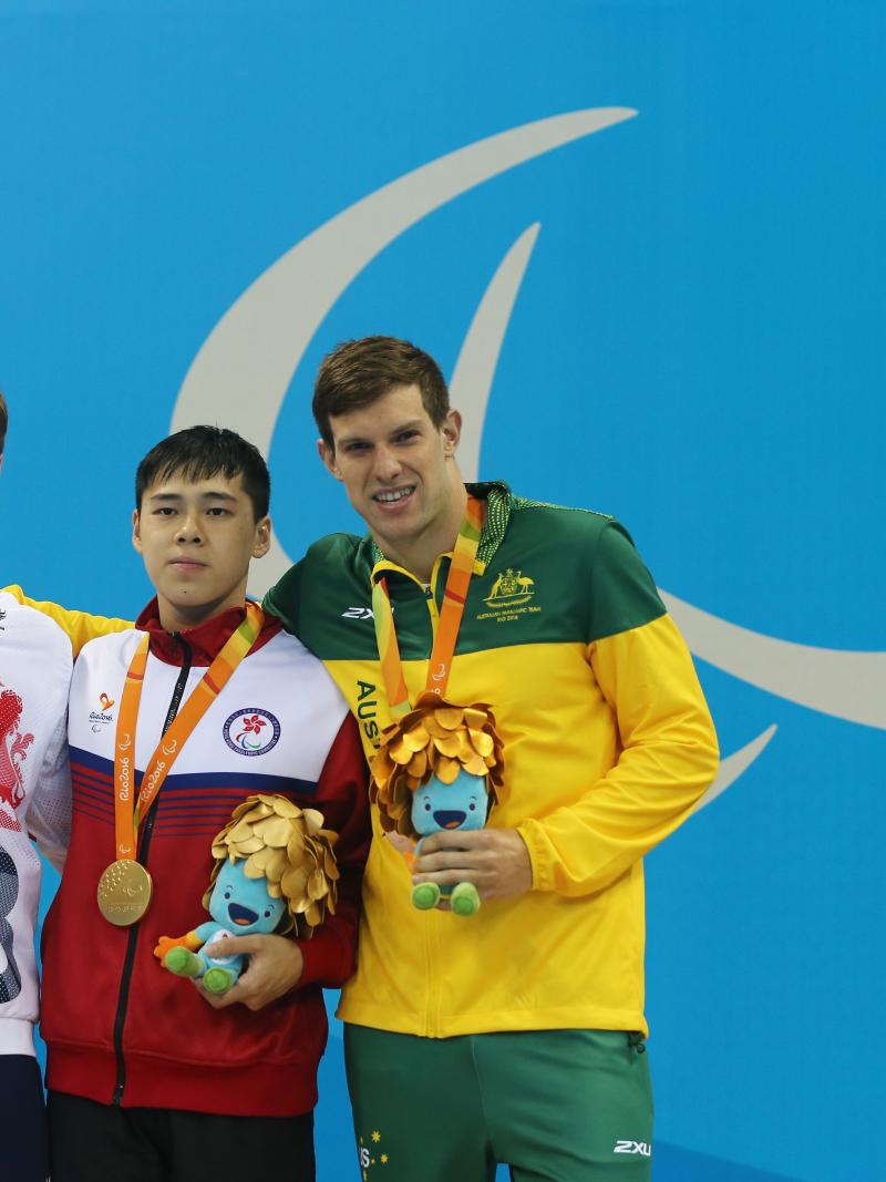 Three male swimmers standing on a podium at Rio 2016