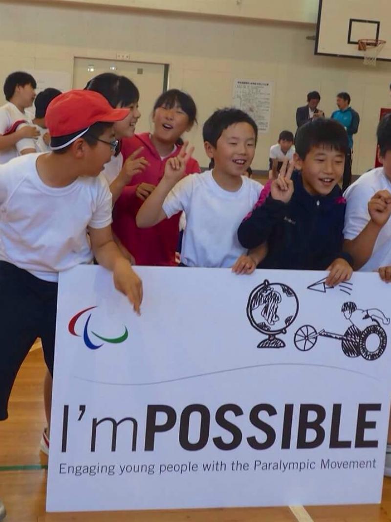 Group of Japanese kids holding up a sign