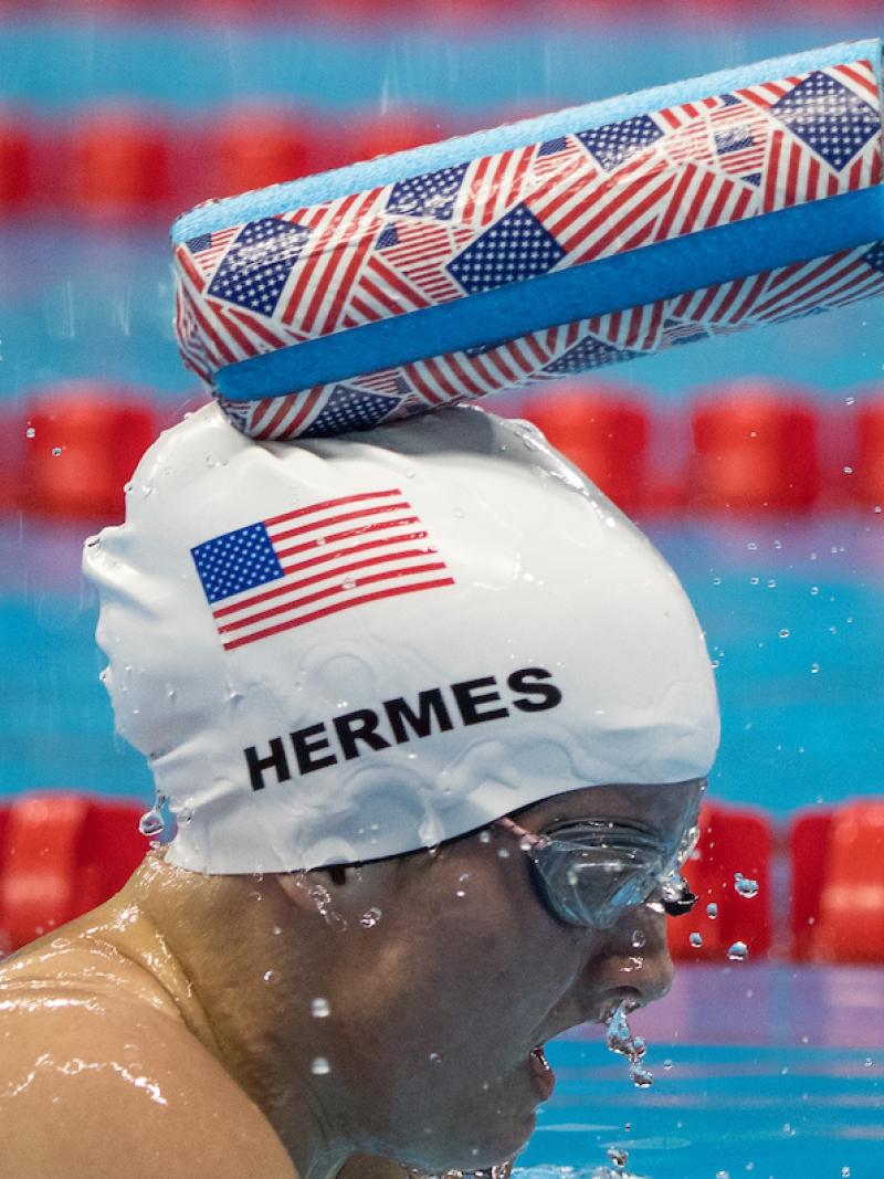 Tapper taps a visually impaired swimmer on the head