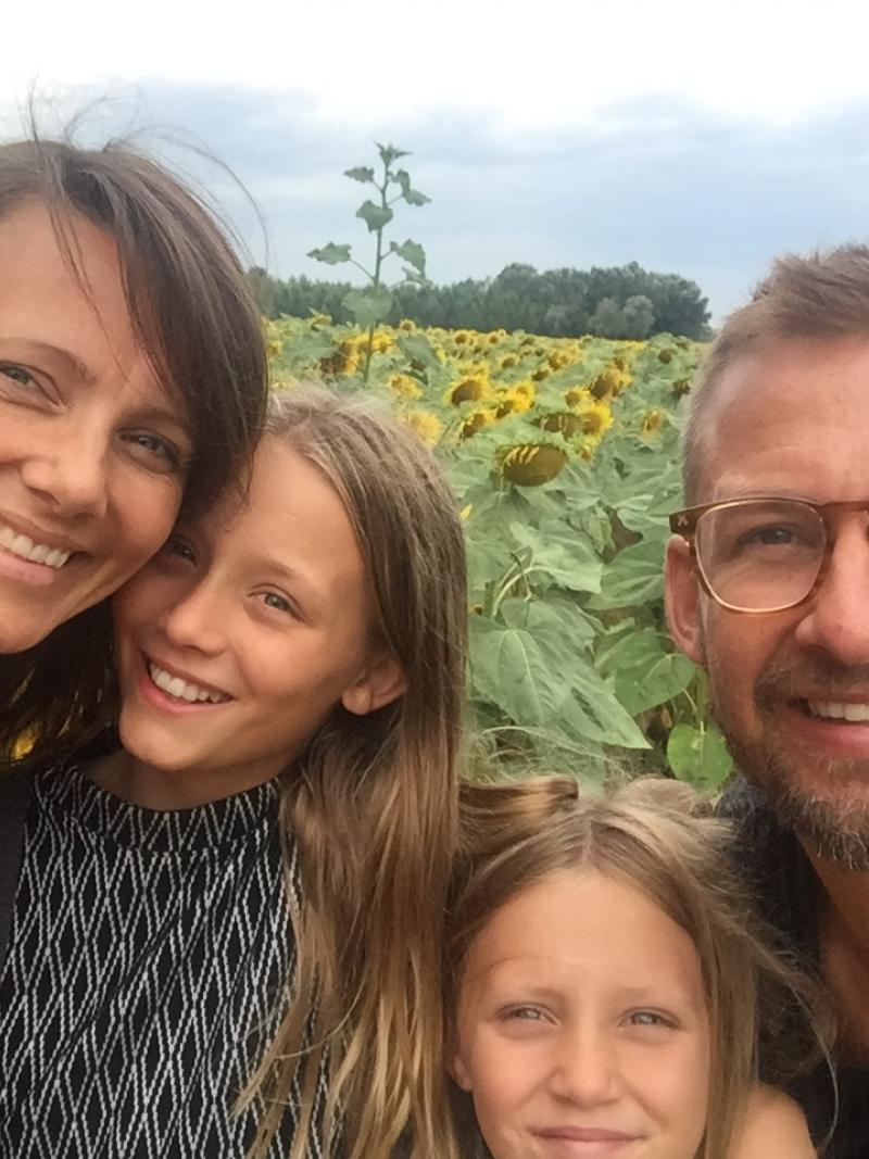 Selfie of a woman, her husband and their two daughters