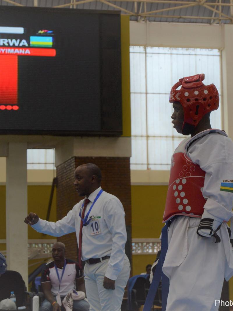 Man in taekwondo uniform at a competition