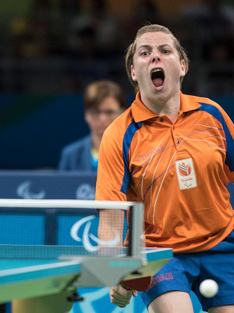 Female table tennis player celebrates after a point