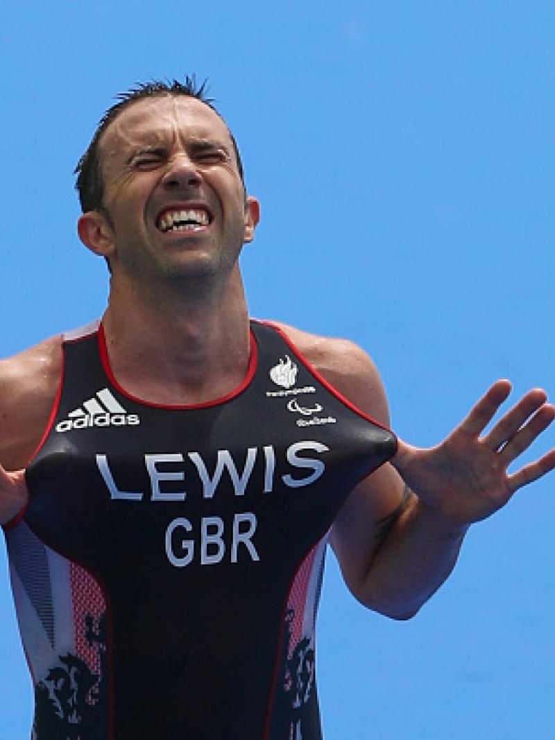 Male triathlete celebrates after winning race