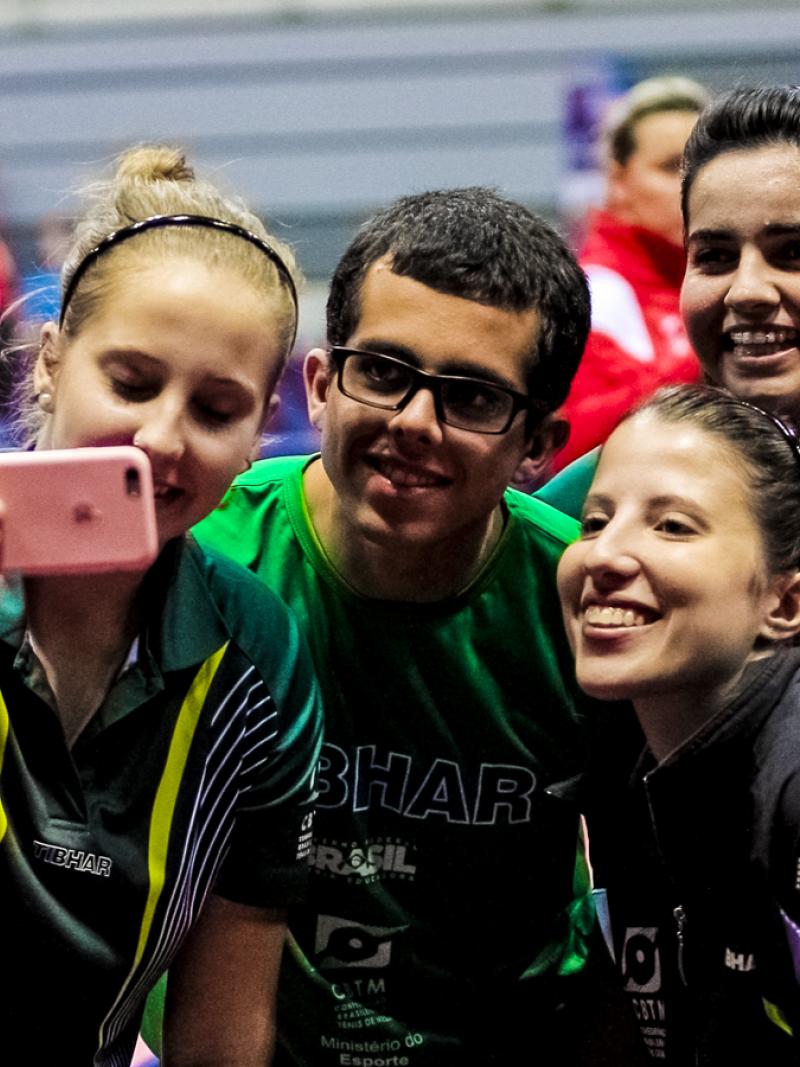 Four people take a selfie