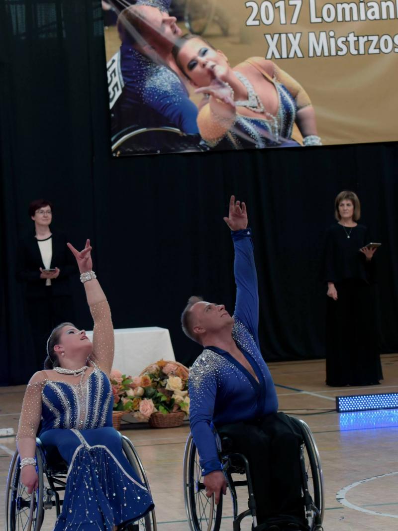 Man and woman in wheelchairs dance