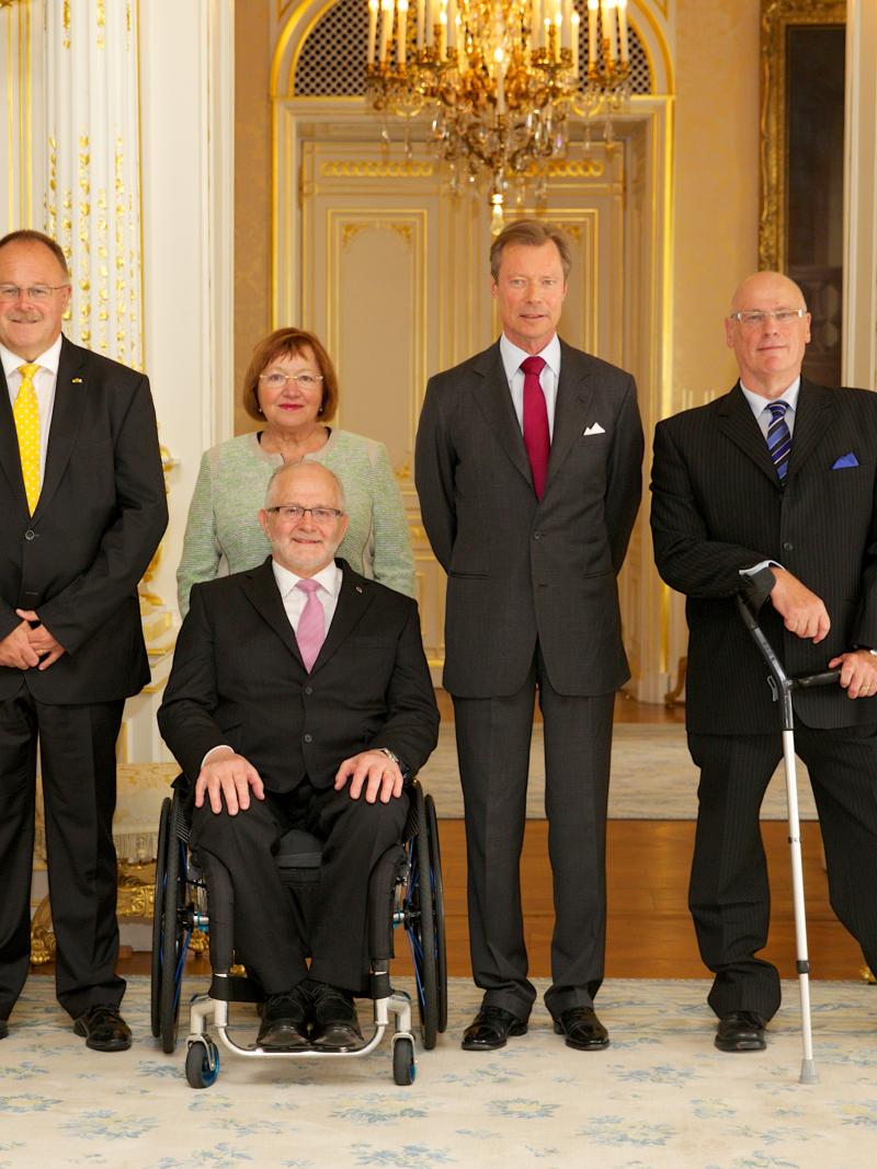 A group of people smiling for an official photograph