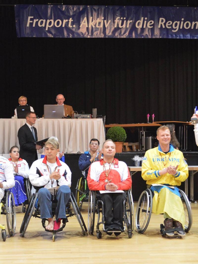 Five male wheelchair dancers on the podium