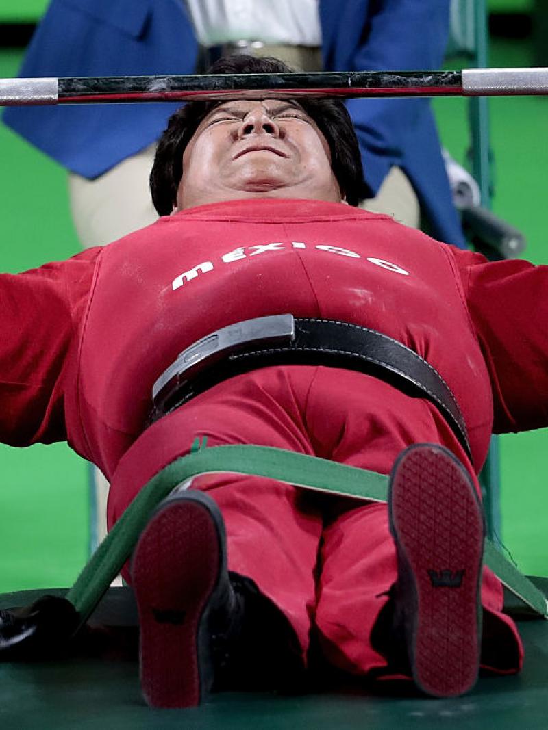 female powerlifter on bench preparing to lift weights