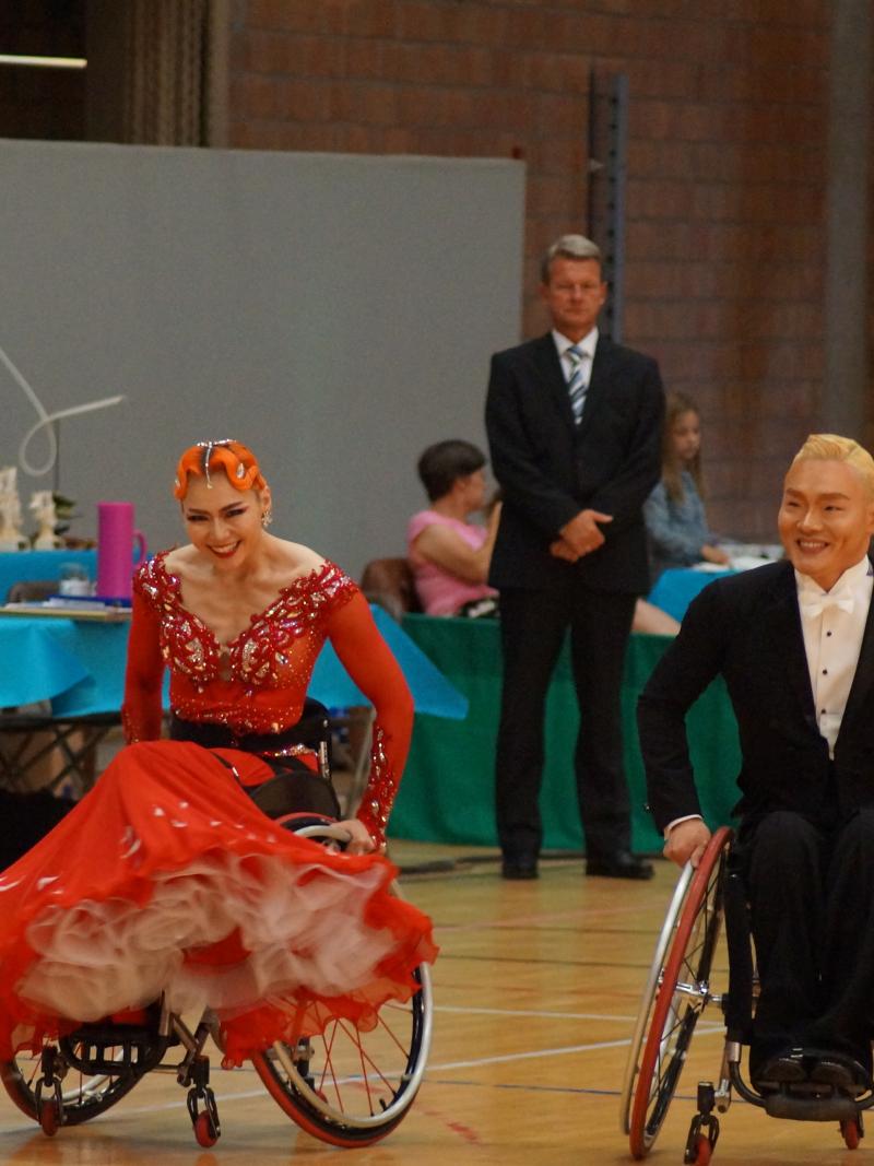 a male and female wheelchair dancer side by side