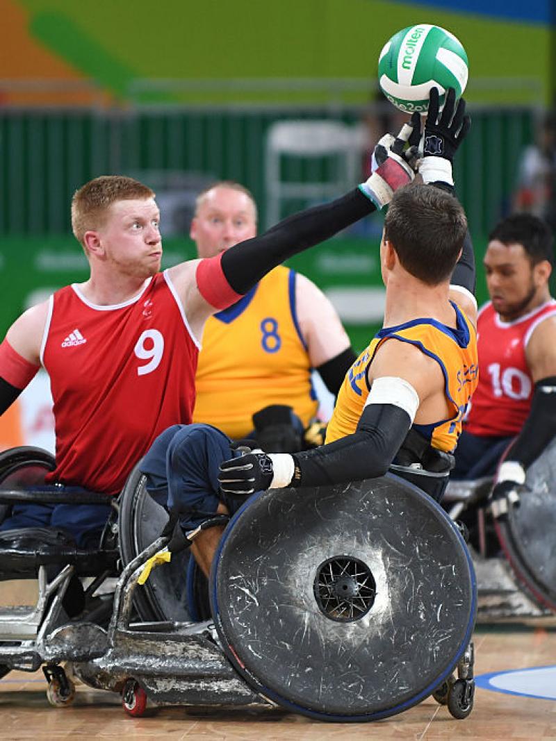 two men contesting the ball in wheelchairs