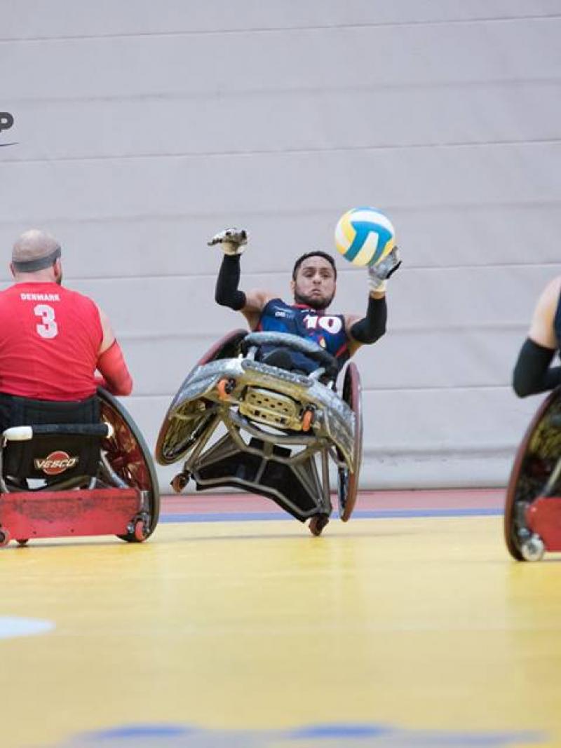 men tackle for the ball in wheelchairs