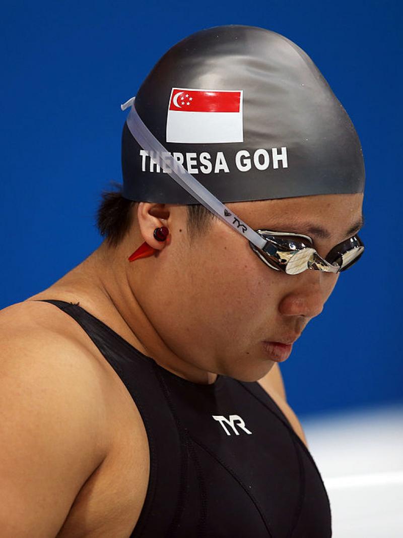 a woman with swimming cap and goggles on