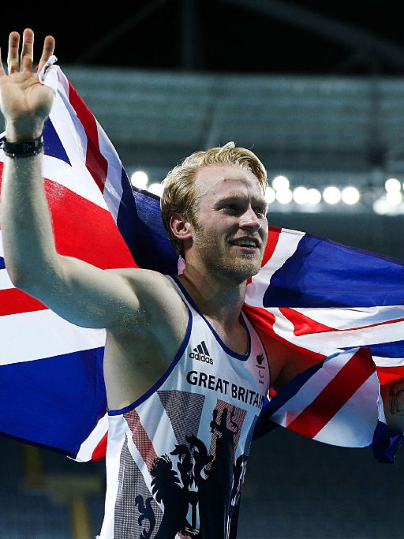 man runs with a British flag