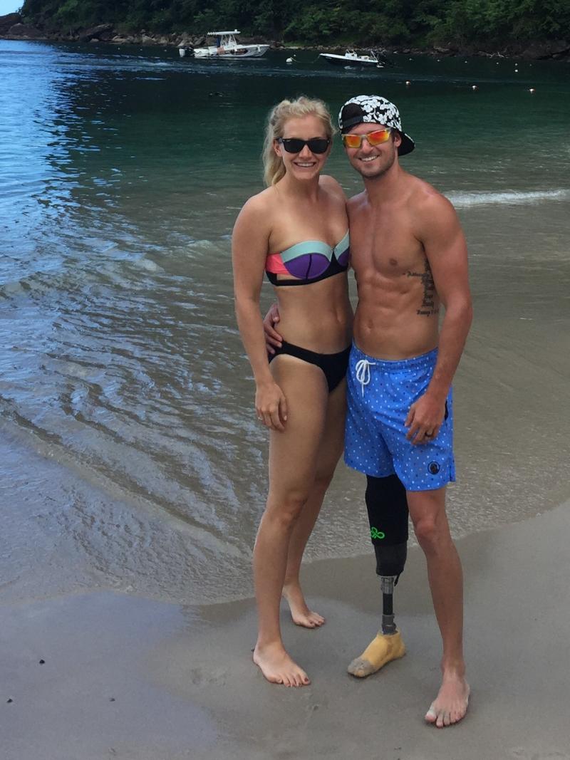 a man and a woman in swimsuits on a beach