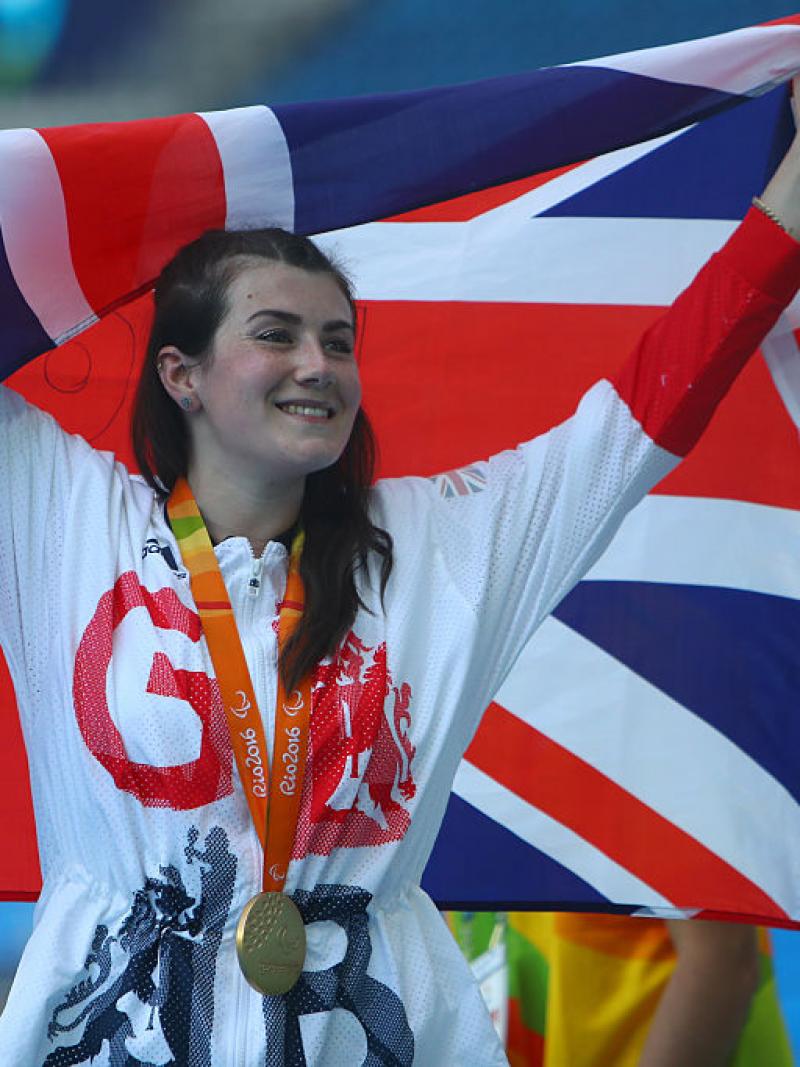 a woman holds up a flag