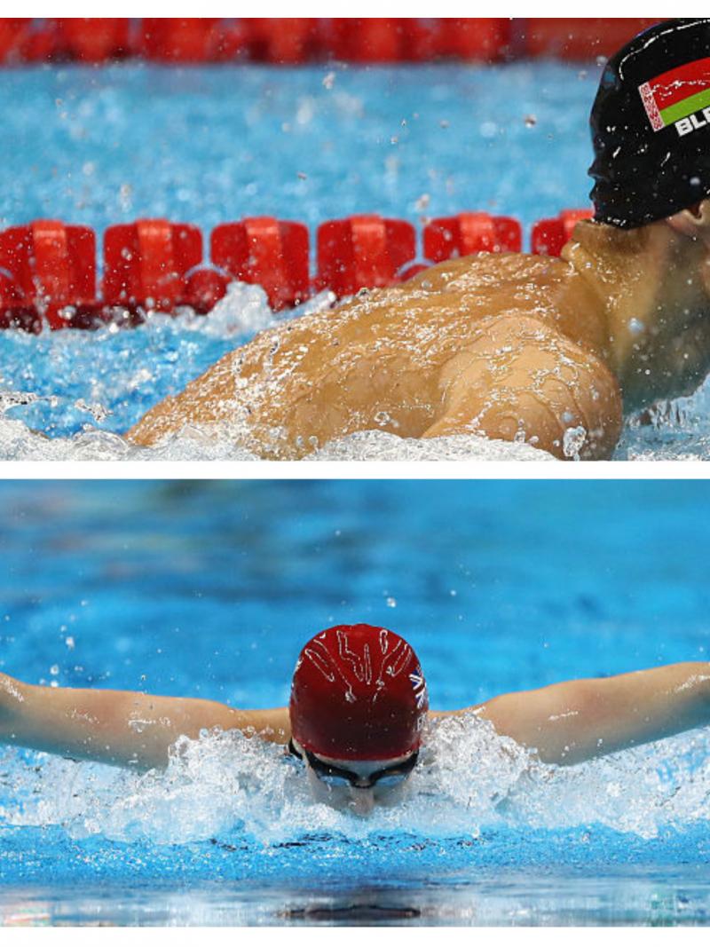 A male swimmer touches the wall and a female swimmer breathes during a stroke