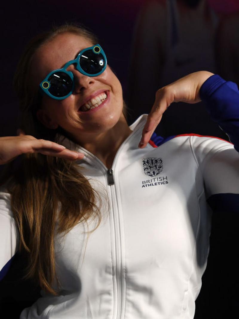 A girl in sunglasses poses for the camera