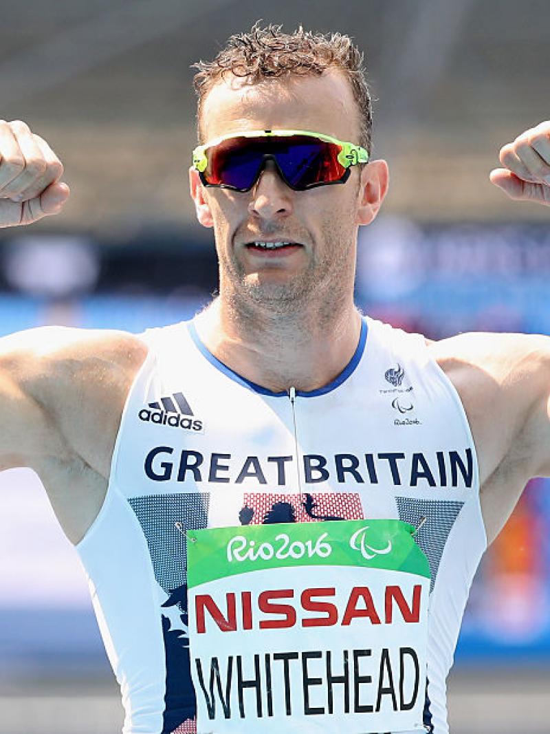 a man raises his arms to show off his muscles