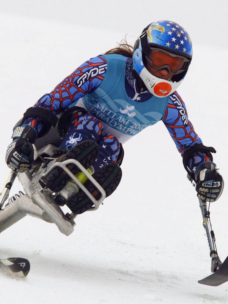 a para alpine skier skies down a slope