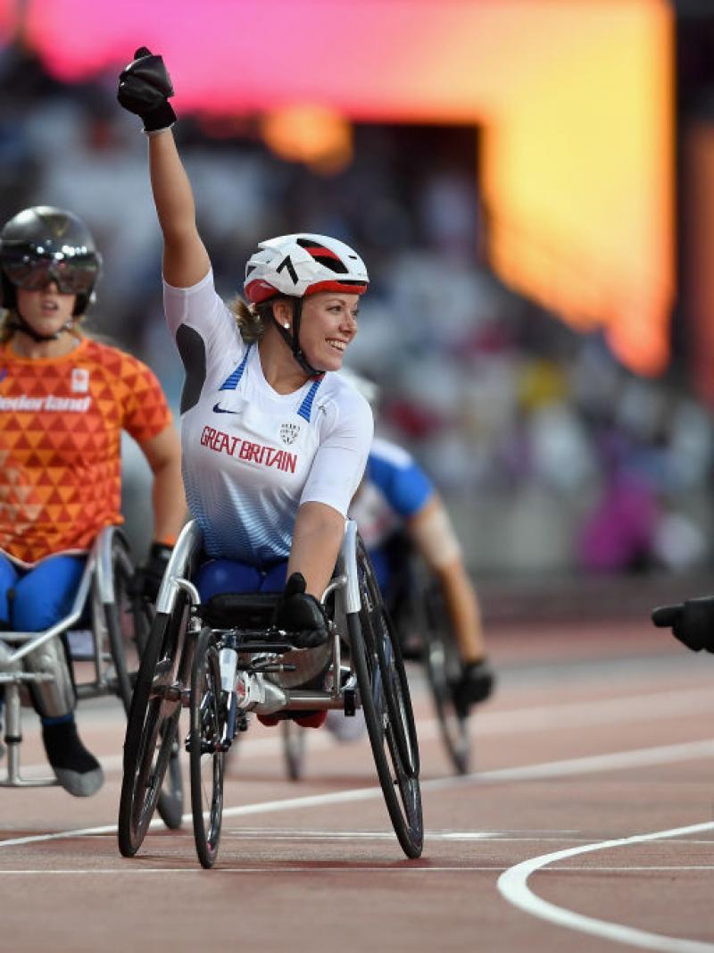 a wheelchair racer celebrates winning a race