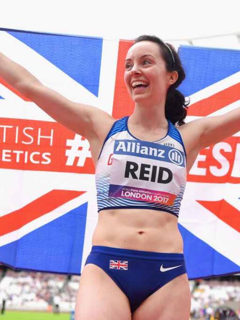 a para athlete holds a British flag