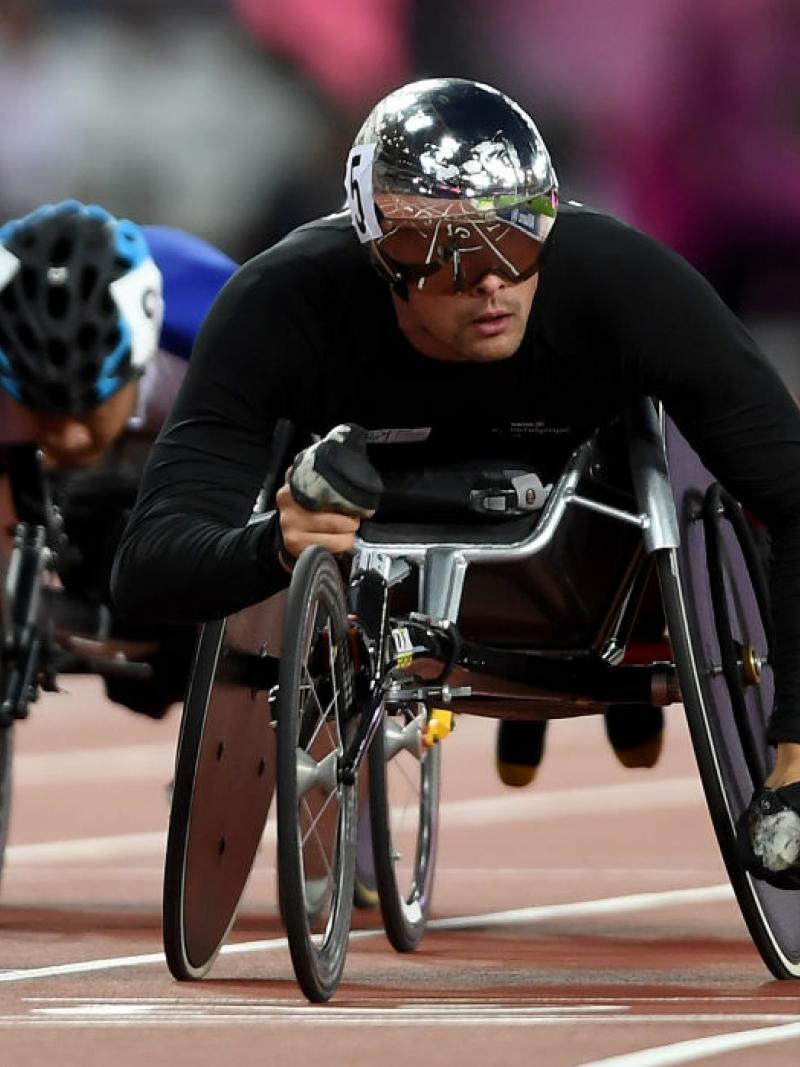a wheelchair racer crosses the finish line