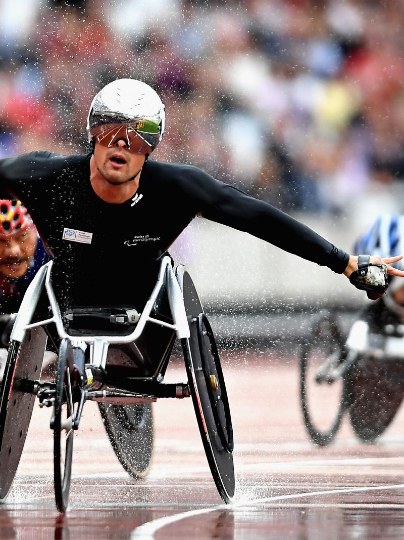The Swiss Silver Bullet celebrates in the rain after winning the men's 5,000m T54 at London 2017.