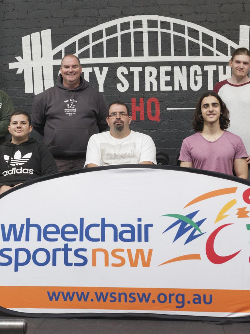 a group of powerlifters pose for a photo