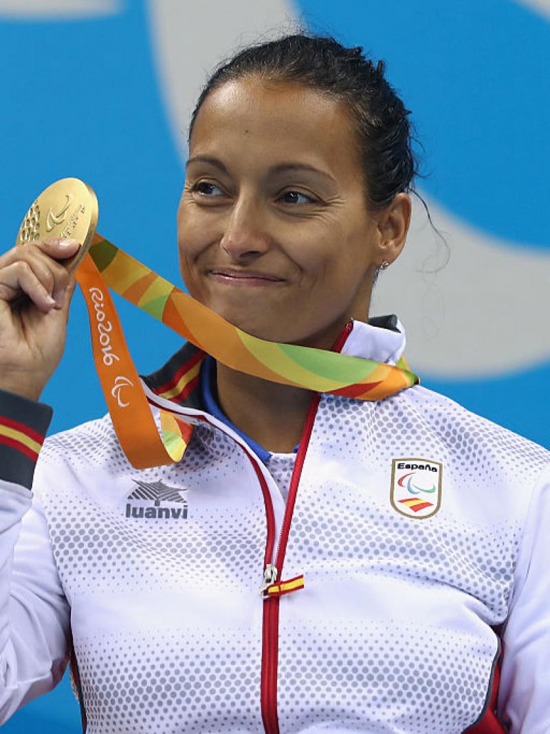 a Para swimmer celebrates with her medal