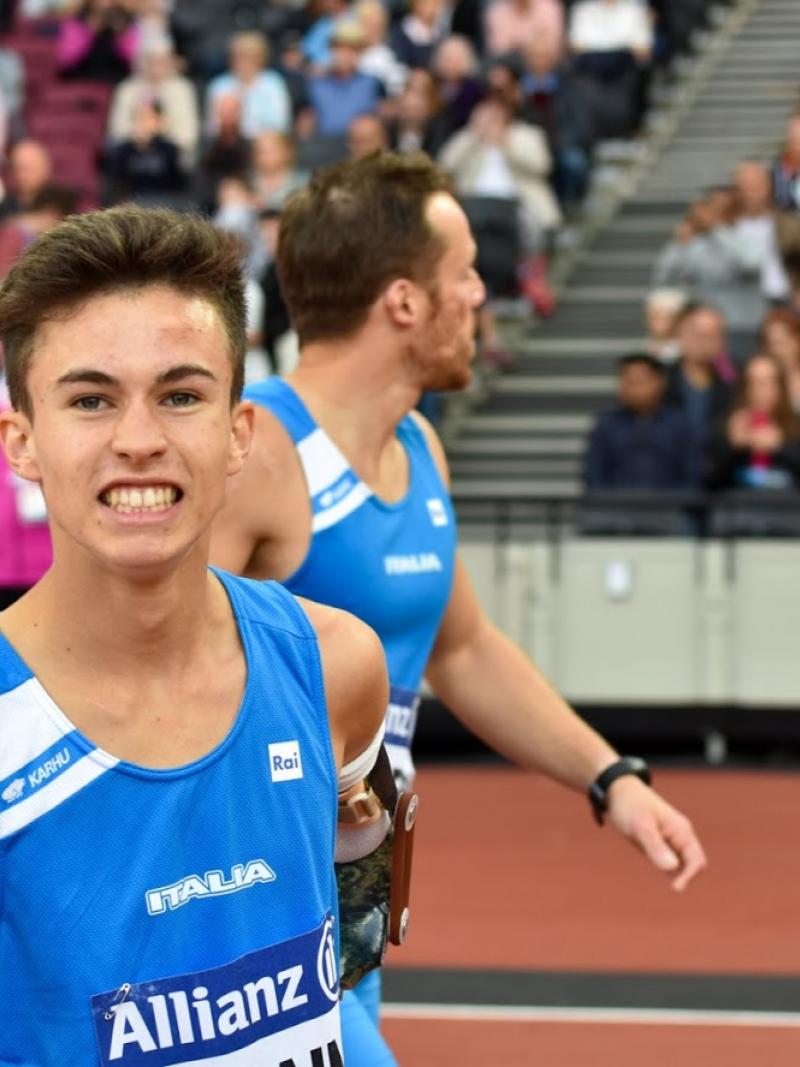 a para athlete celebrates by shaking his fist