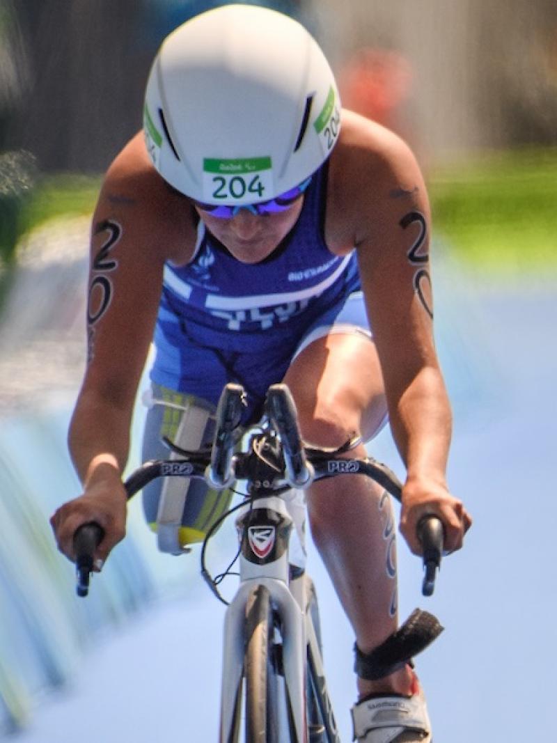 a Para triathlete cycles on a bike