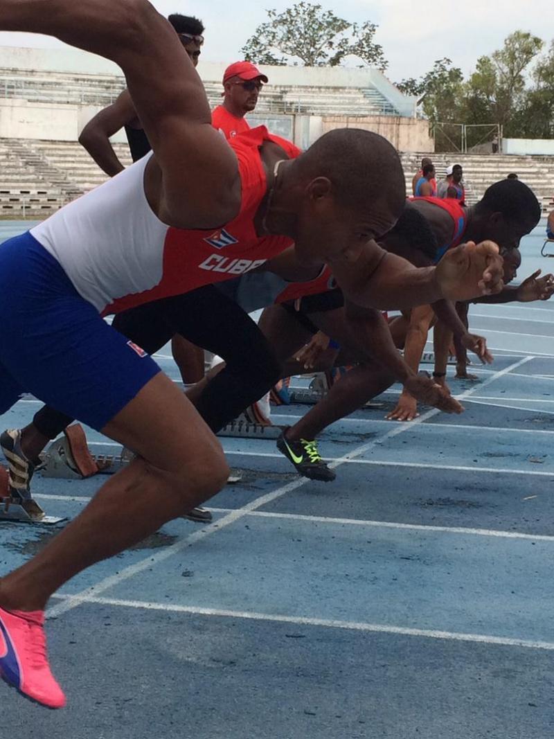 a group of Para sprinters spring from the blocks