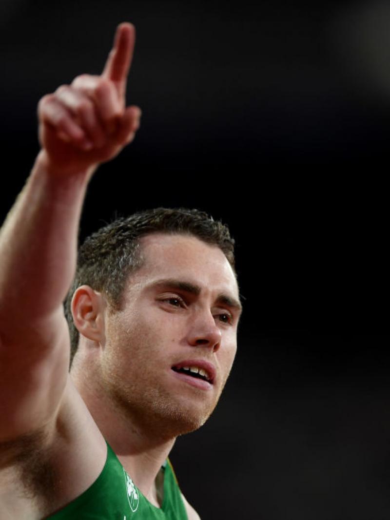 a man raises his arm in celebration
