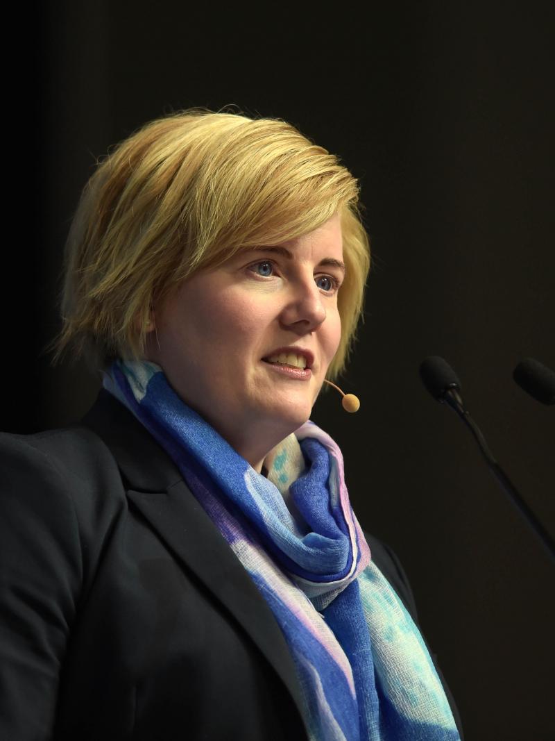 A woman speaks at a podium