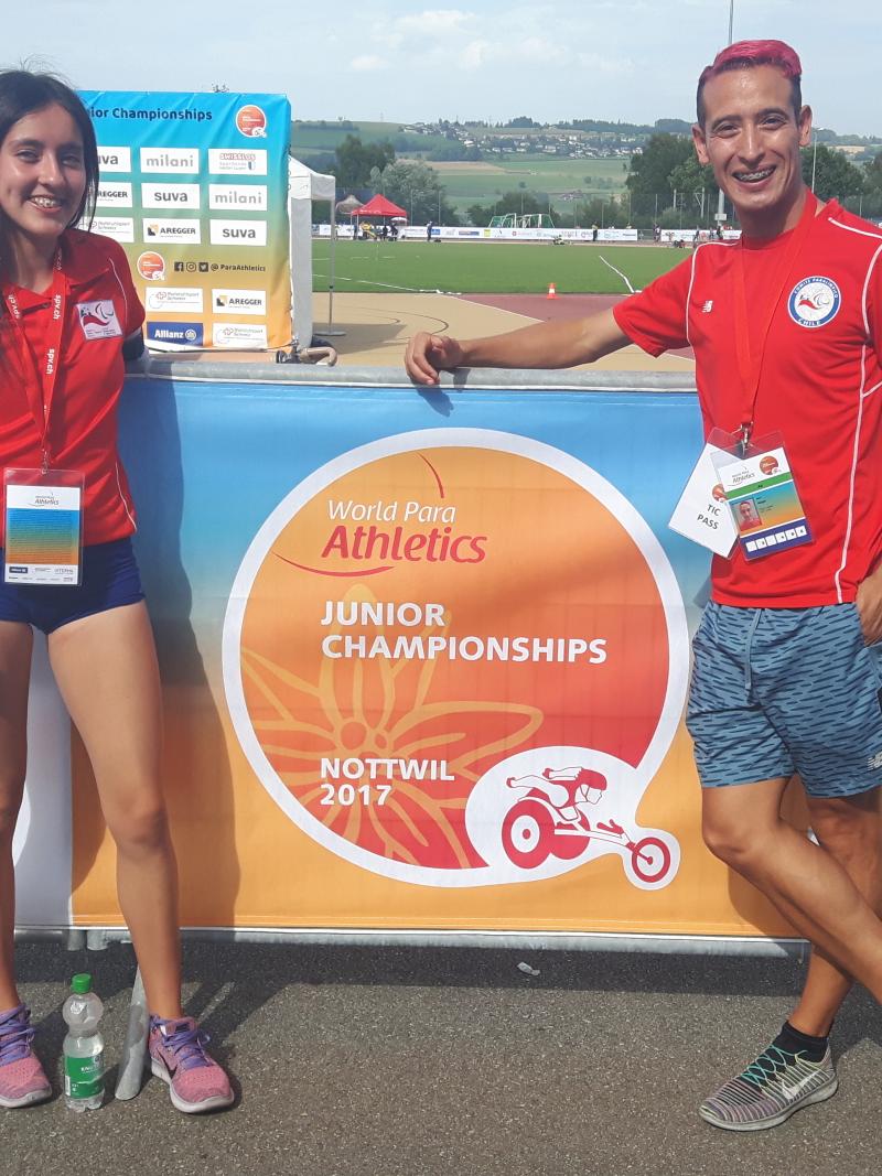 Man and woman pose for a photo on the track