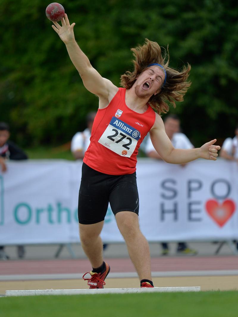 Athlete throws a shot put