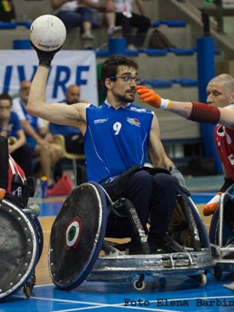 wheelchair rugby players battle for the ball