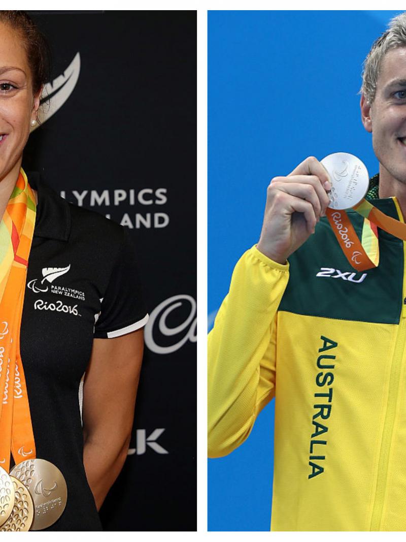 A male and a female swimmer pose with their medals