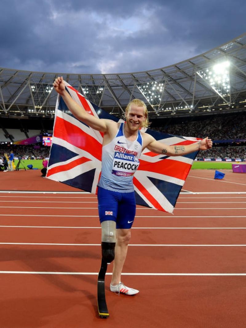 a Para sprinter celebrates winning with a Great Britain flag