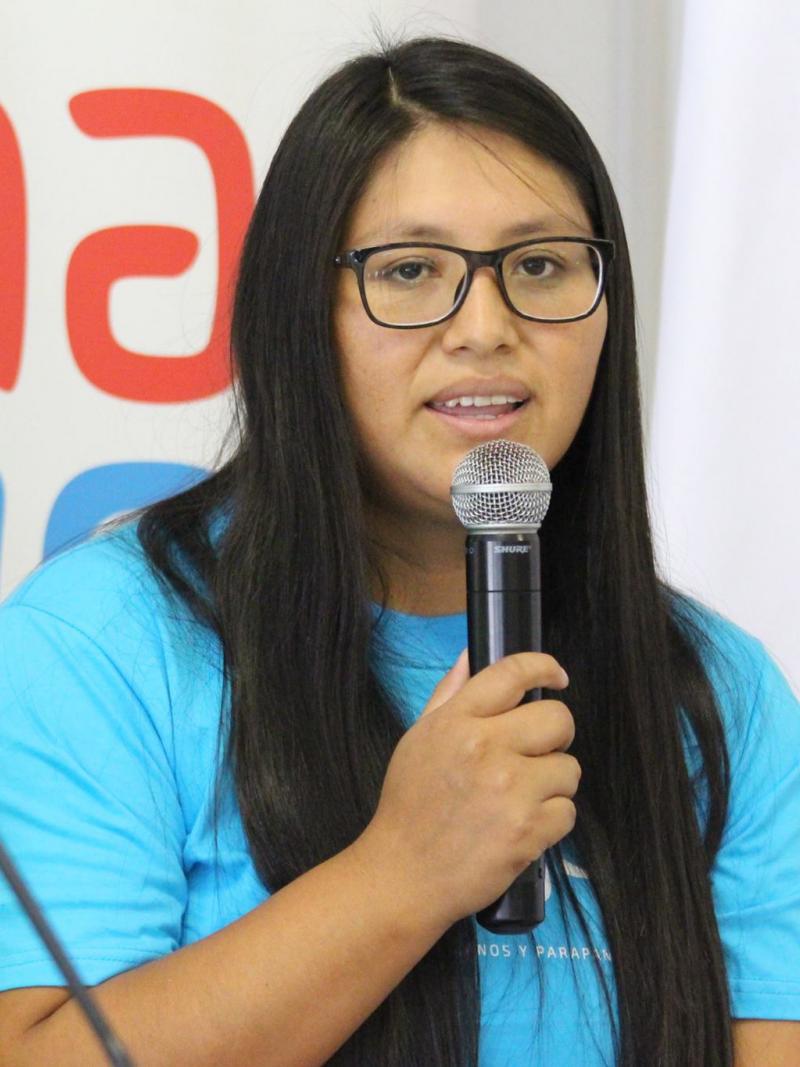 a female Para athlete speaks into a microphone