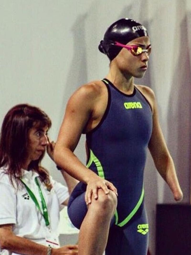 a female Para swimmer waits by her lane