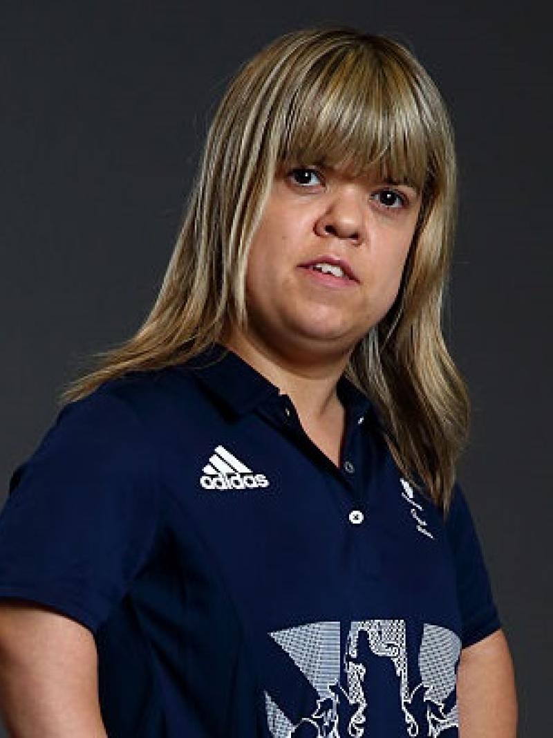 a female powerlifter looks into the camera