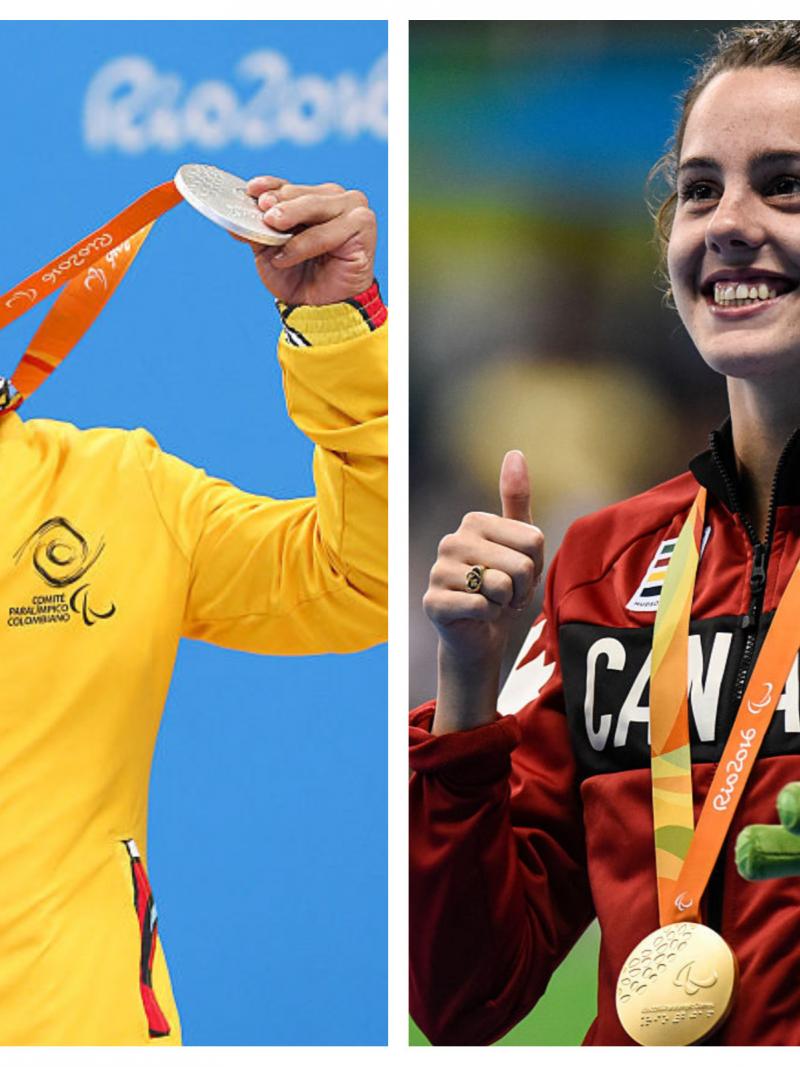 a male and a female para swimmer celebrate with their medals