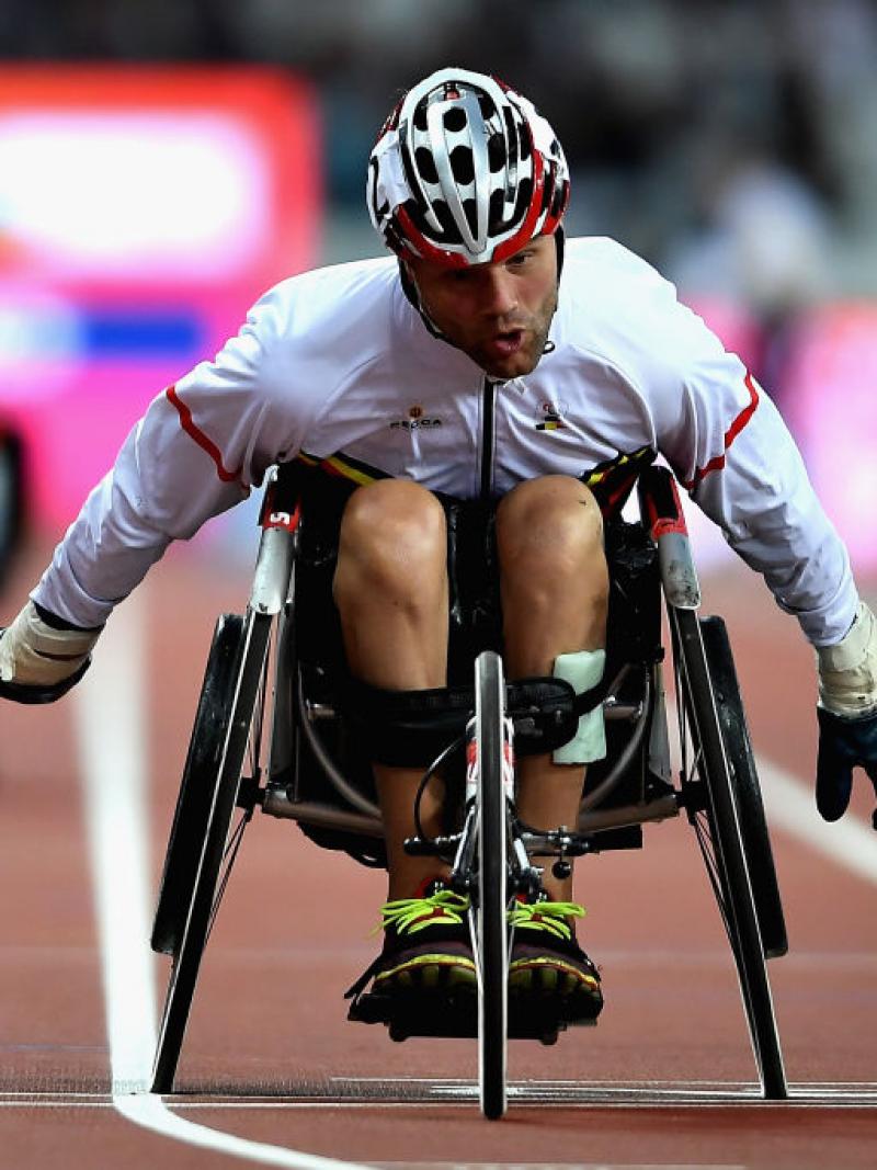 a male wheelchair racer sprints for the line