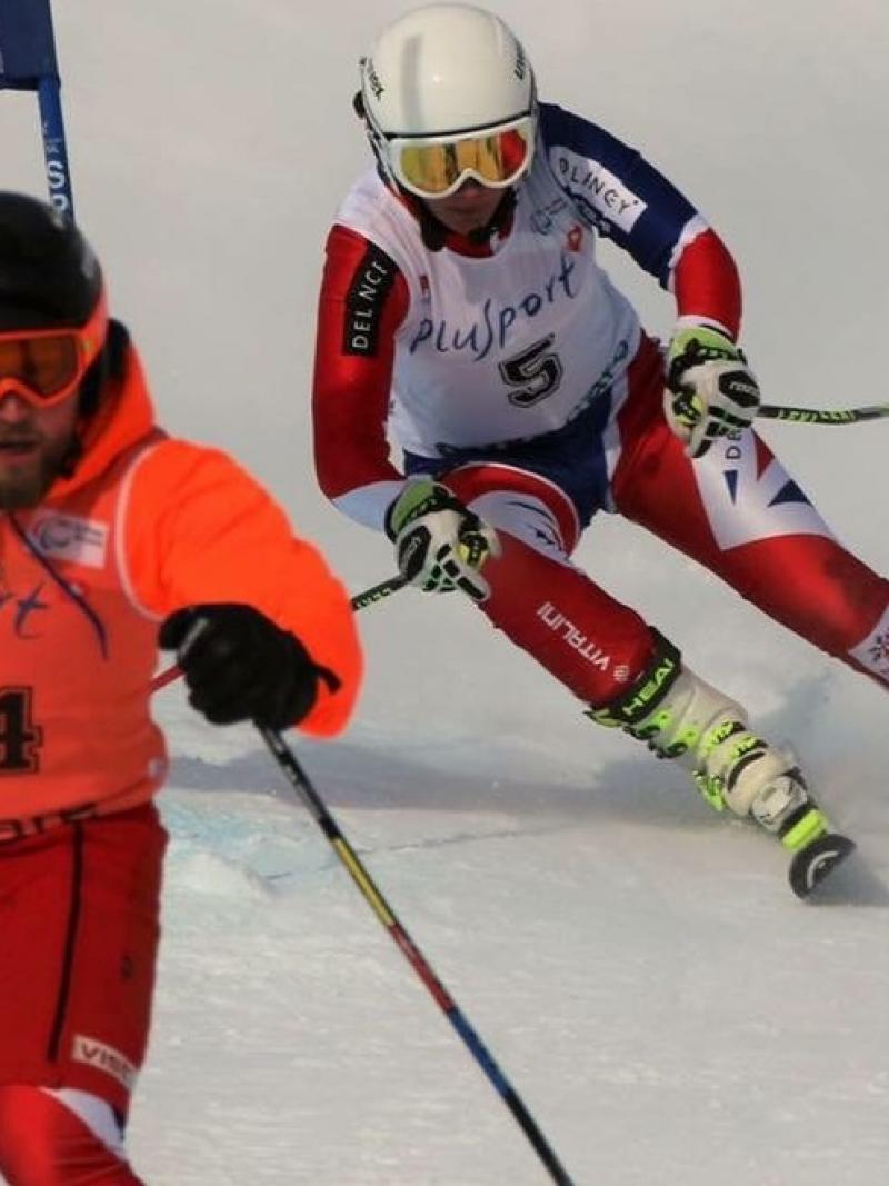 A Para skiier and her guide ski down the slope