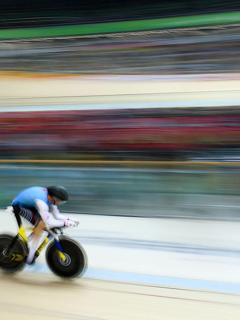 a Para cyclist speeds around the track