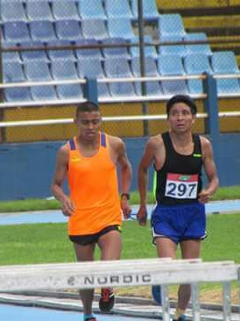 a Para athlete and his guide race on a track