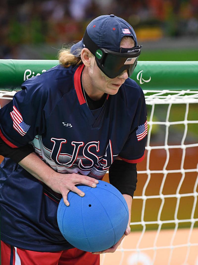 a female goalball player stands by the goal